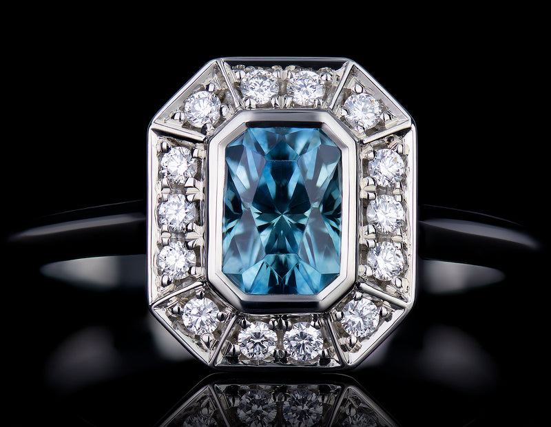 Finished emerald cut aquamarine with diamond halo ring