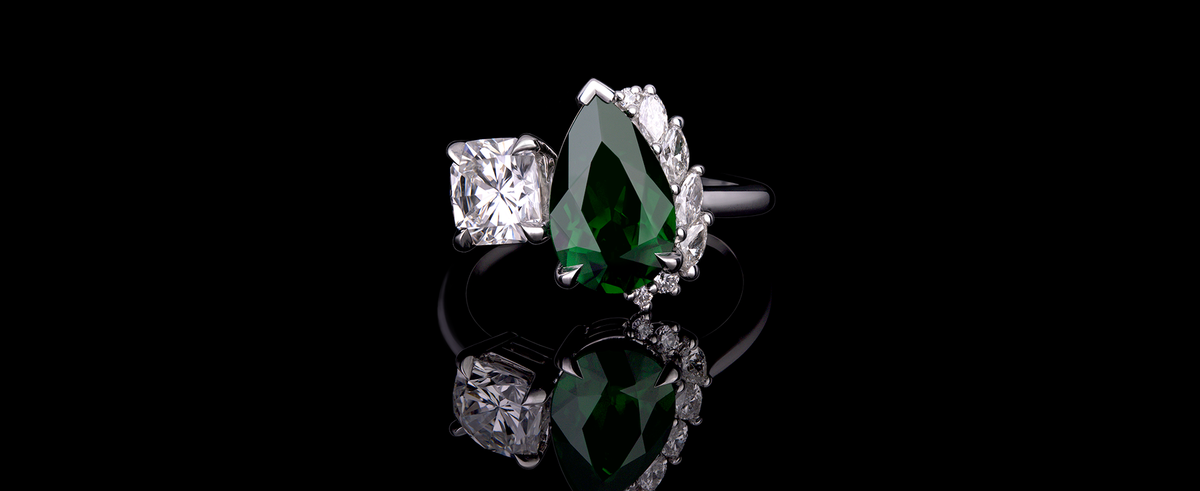 Toi et moi ring featuring a large pear-cut green tsavorite and a square cut diamond