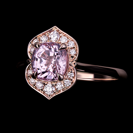1.30 CT Cushion cut pink spinel center stone set in 4 talon claws. Surrounded by diamonds in a bright cut halo, made in 14k rose gold mount.