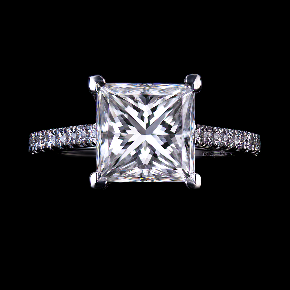 2.46 CT Princess cut diamond set in platinum mount with 4 V-tip prongs.