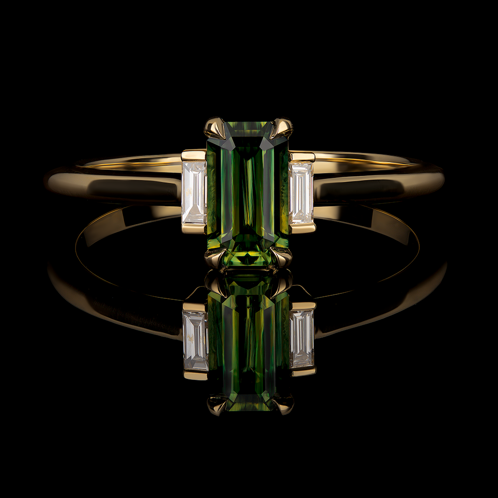 Green 0.85 CT emerald cut sapphire center stone with emerald cut diamonds on each shoulder.