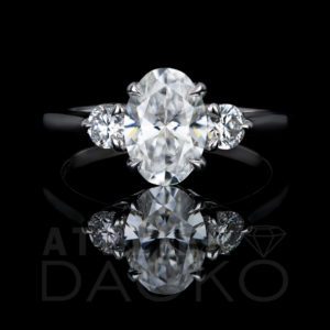 Front Facing 0.94 CT Oval Diamond in a Three-Stone Engagement Ring Setting