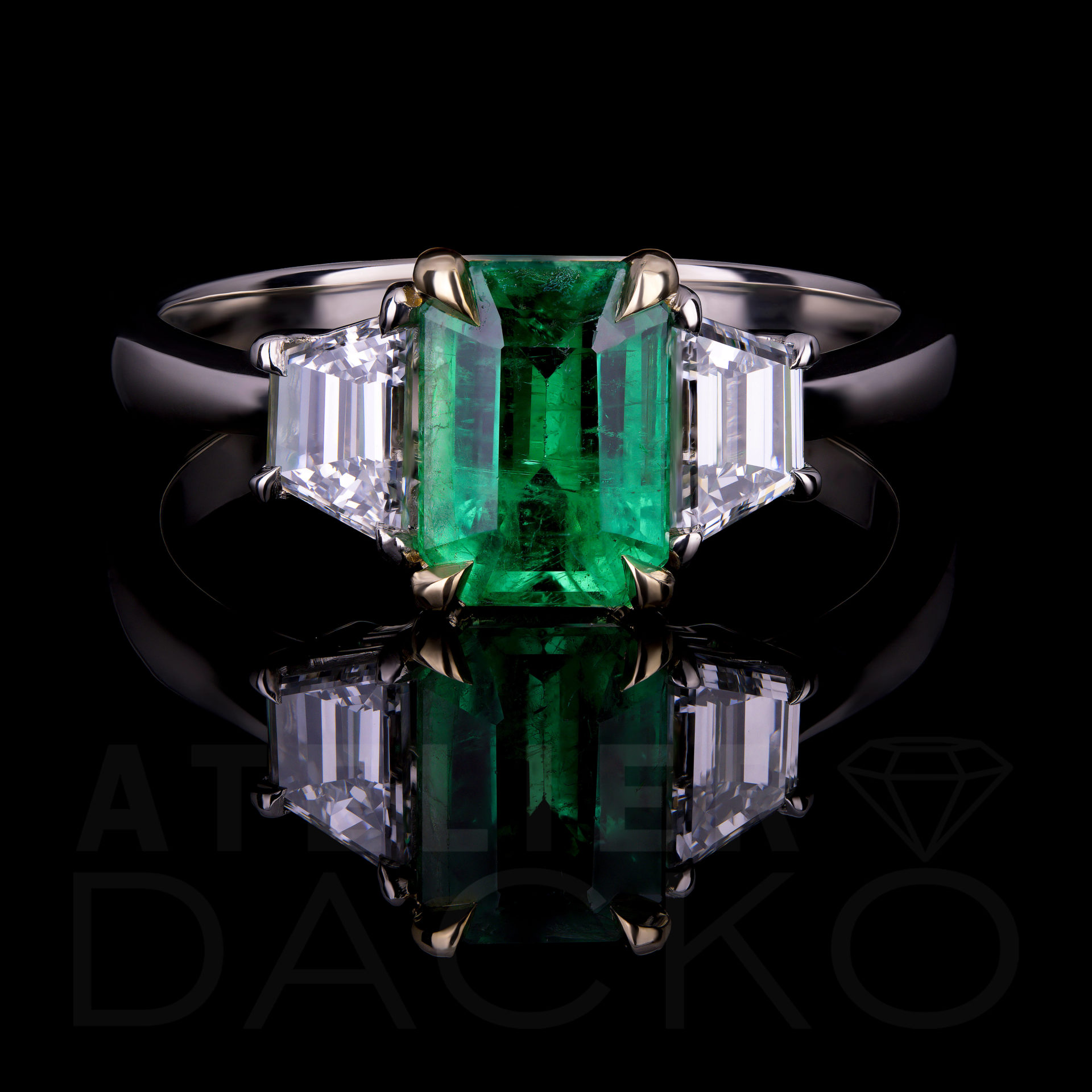 1.50 CT Emerald Ring With Trapezoid Diamonds In Three-Stone Setting